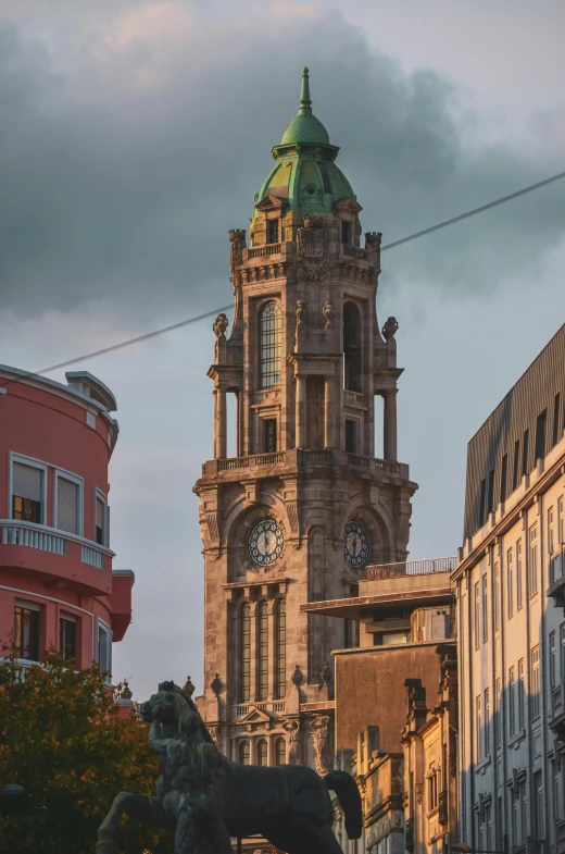 a large clock tower sits in the center of an old city