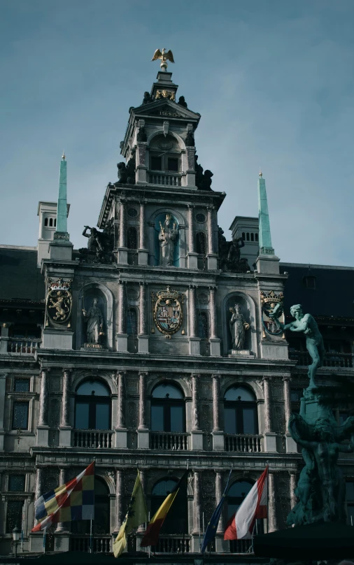 an old building with clocks and statues on it