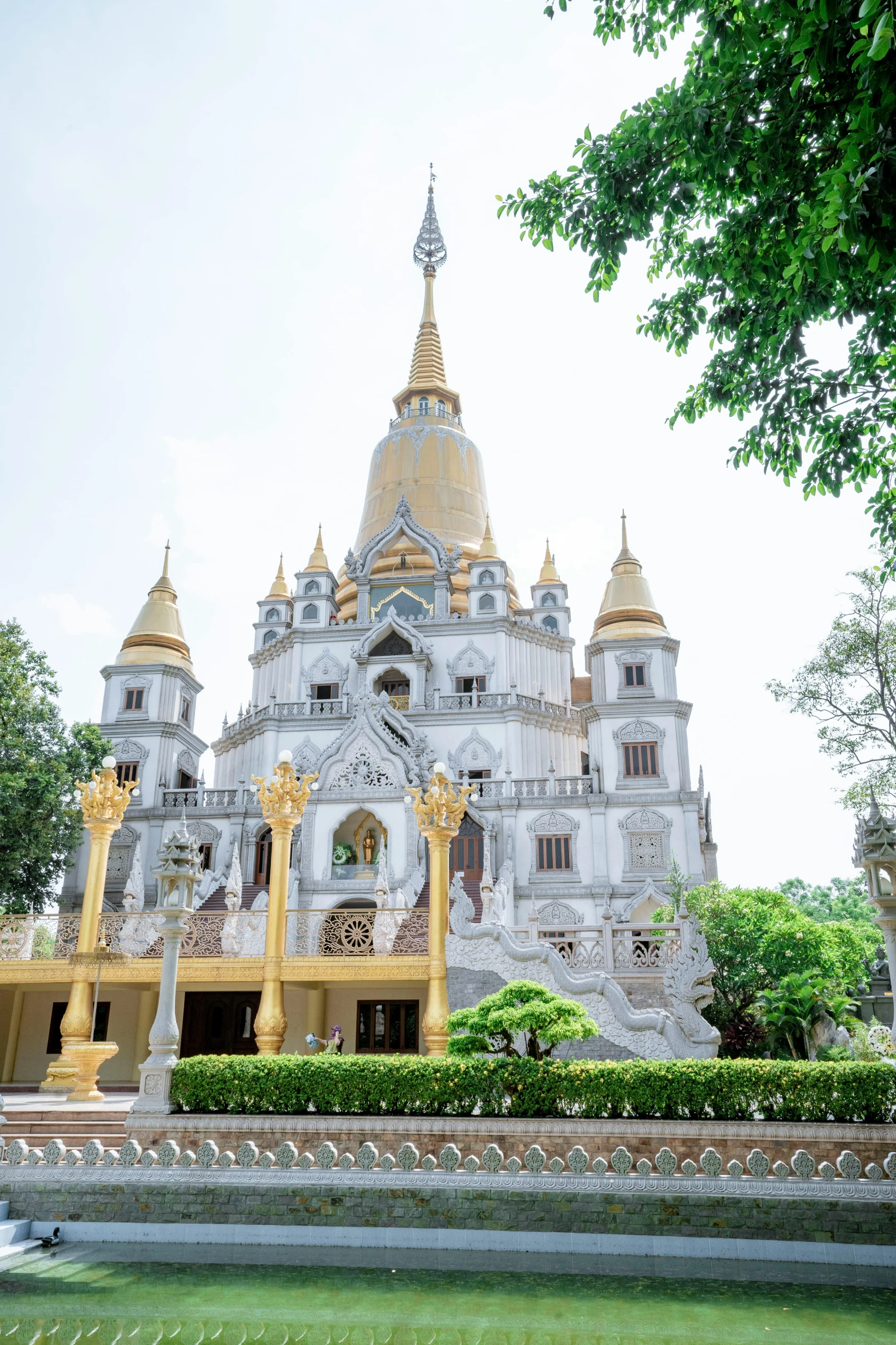 a building that has two towers with gold tops and many spires