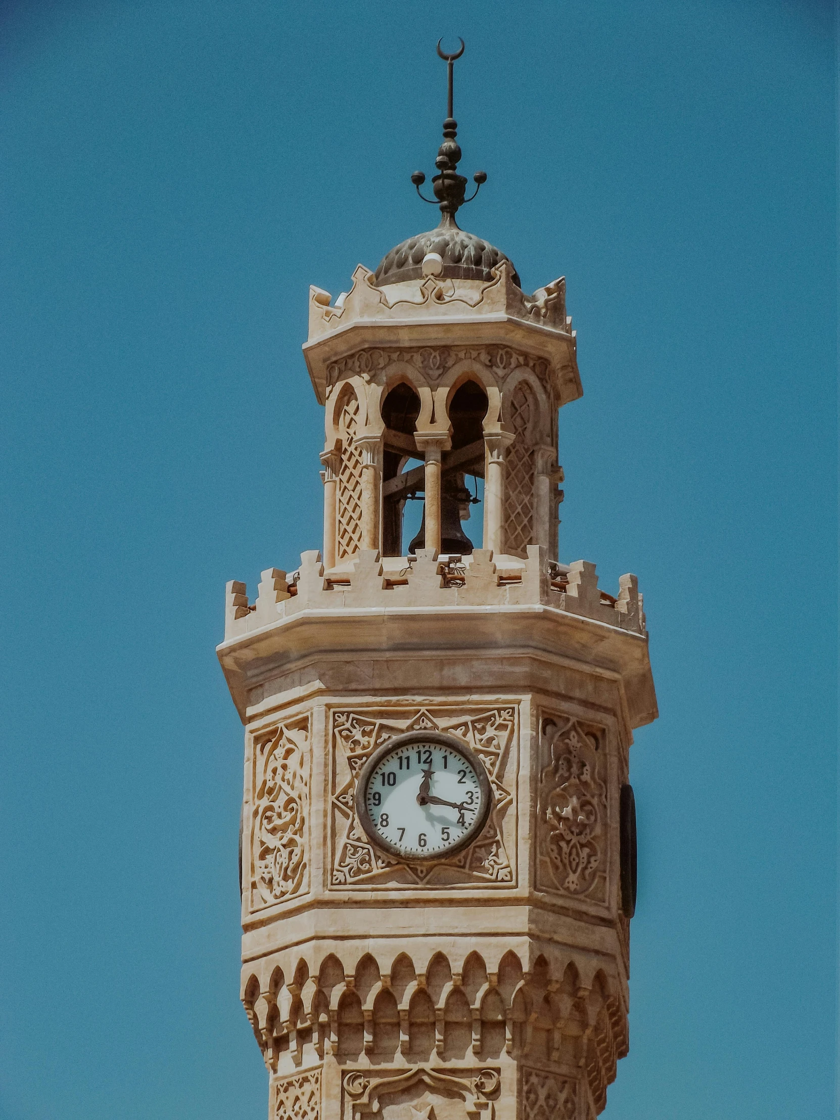 a clock tower on top of a roof next to a clear sky