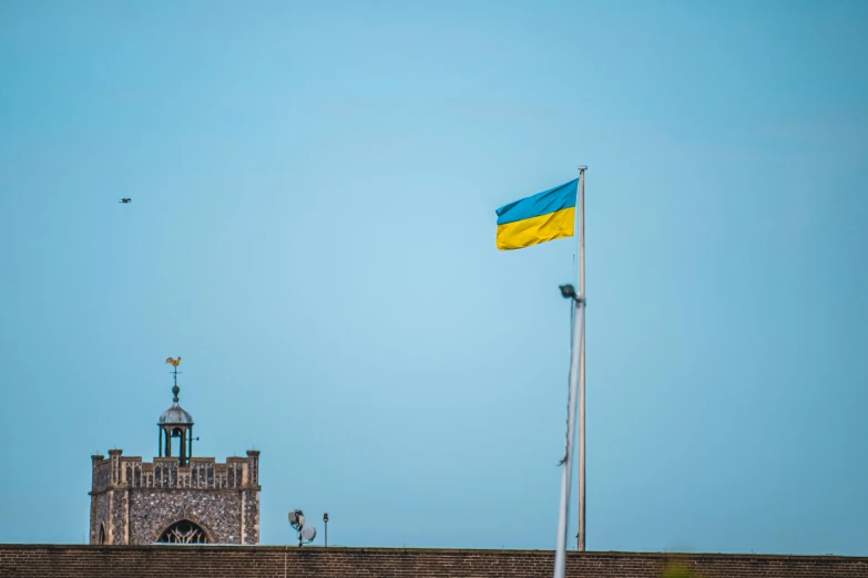 flag flying over the old stone wall of a city