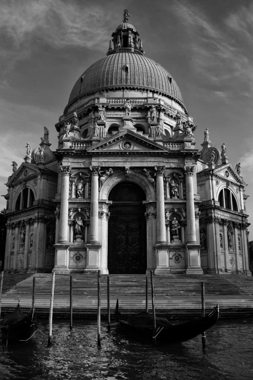 an architectural building on the water's edge with a dome