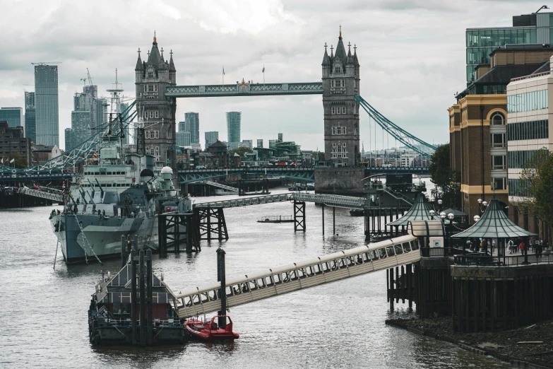 a boat is sailing near some city buildings and bridge