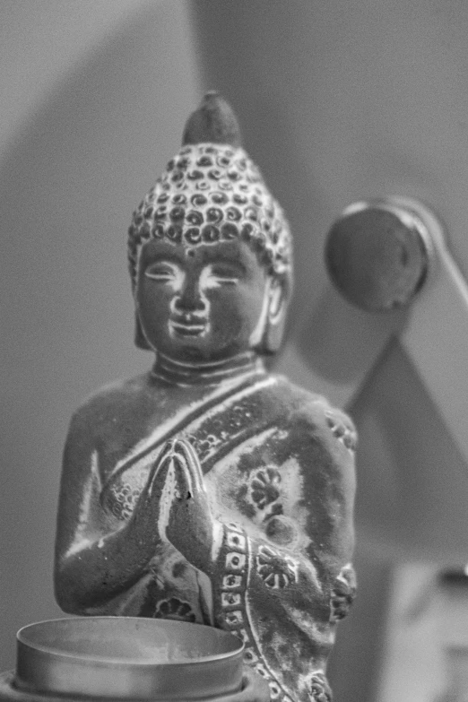 black and white pograph of a statue near a wall