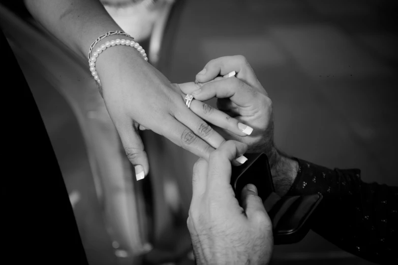 a couple is showing each other their wedding rings