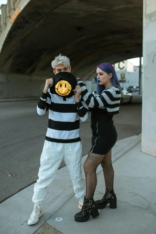 the man and woman is posing on the street