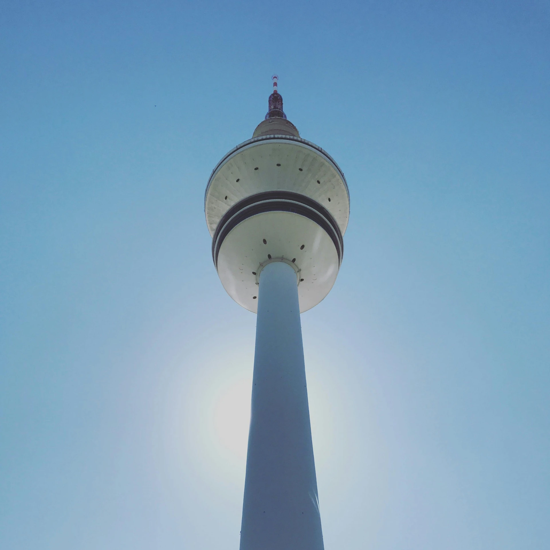 a tall white tower with a very large top