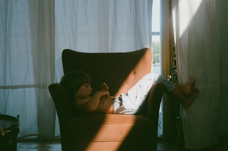 a person sitting on a chair and feeding