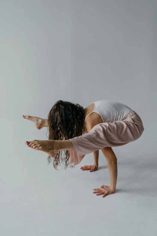 a woman doing a handstand in the air