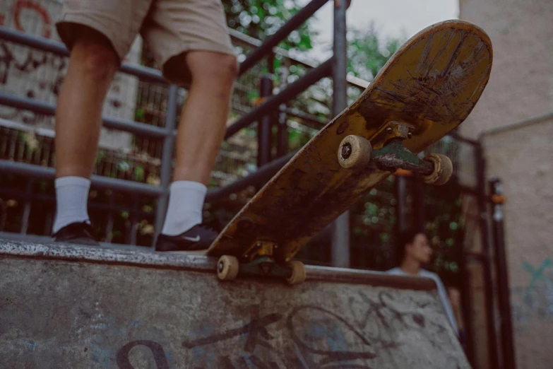 the person is riding their skateboard up the ramp