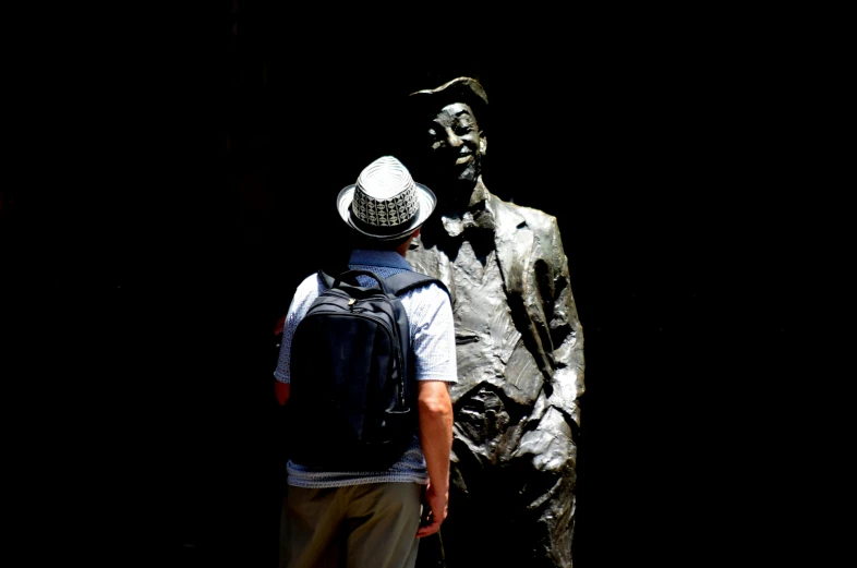 two men who are looking at a statue