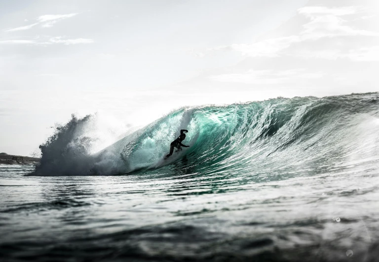 a person on a surfboard riding a wave