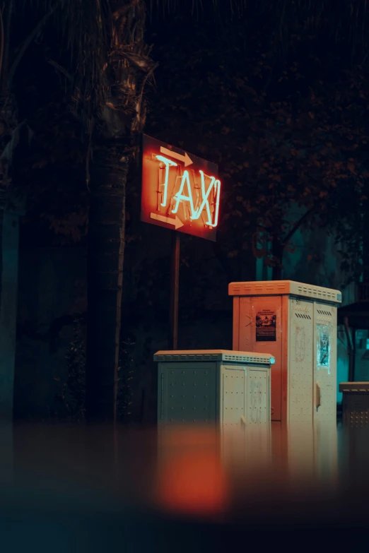 a taxi sign lit up on top of a trash bin