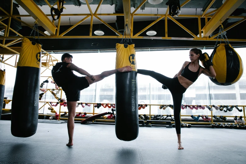 two girls in a gym engaged in a kickbox fight