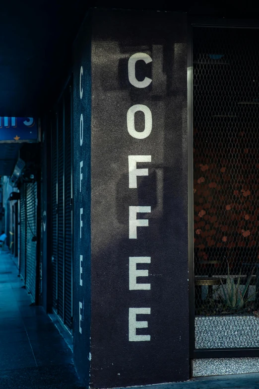 a black coffee sign outside the front of a store