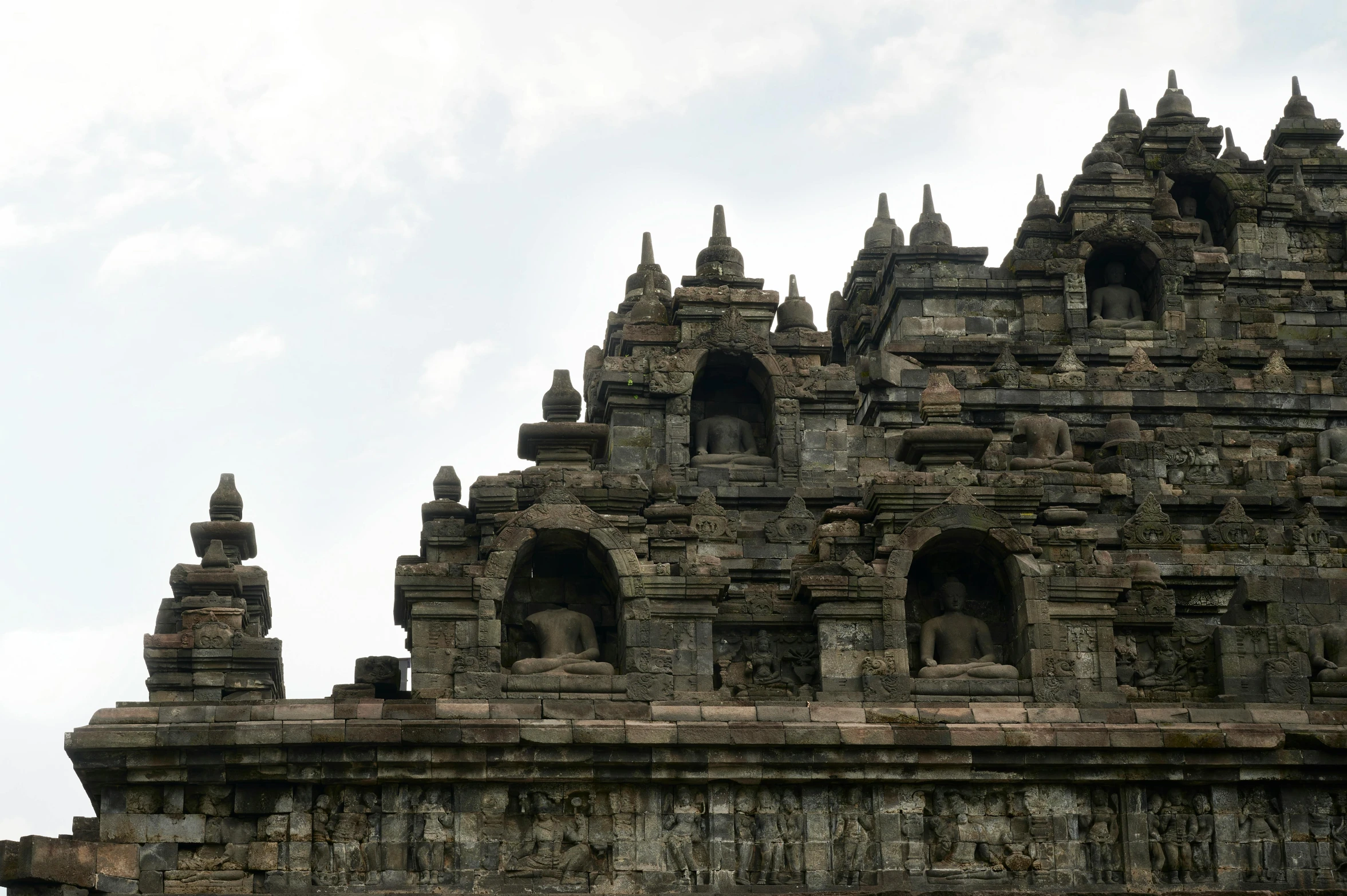 an ornate stone building with arches and spires