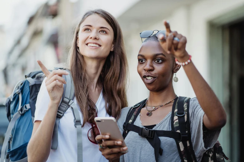 two women in a city with cellphones