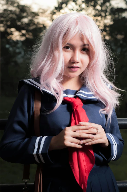 a beautiful woman with long pink hair in a blue jacket and red tie