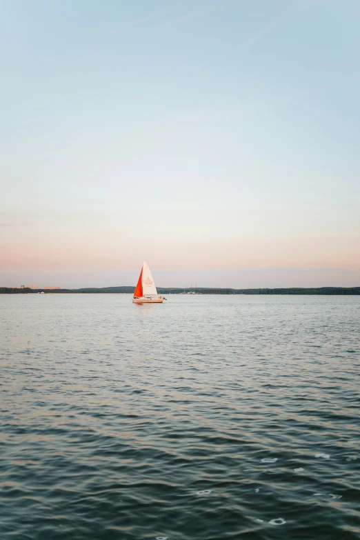 a small sail boat sits in the water