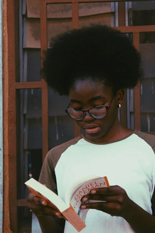 an african american girl reading the book that contains her name