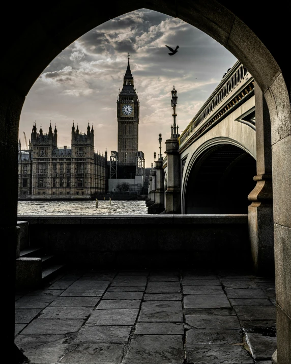 an arch view of the big ben clock tower, and the thames thames