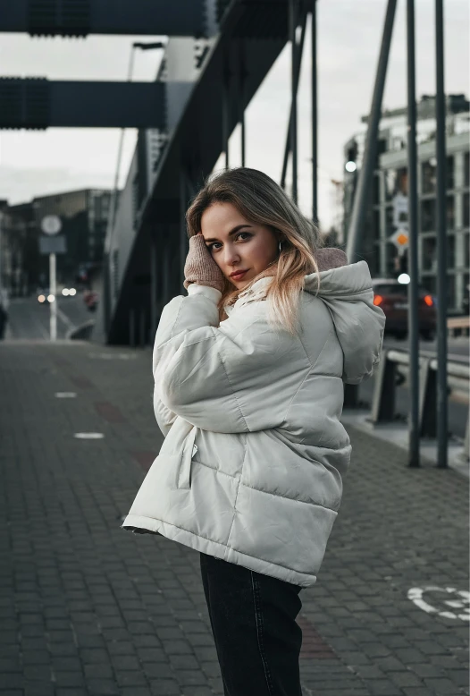 woman in a hooded jacket talking on the phone