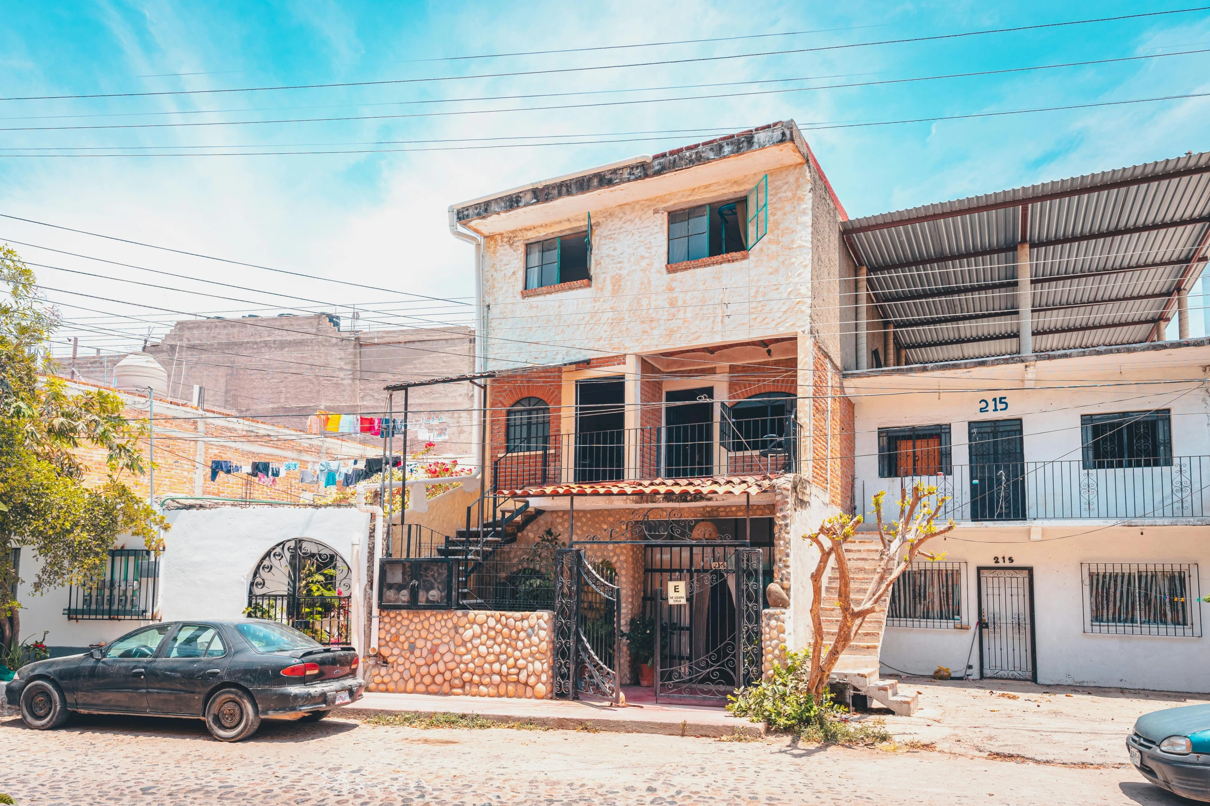 an old brick building in front of another house