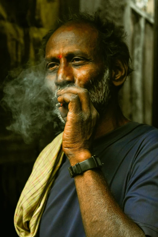 a man is smoking soing while wearing a watch