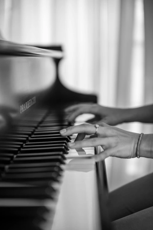 there is a woman's hand playing the piano