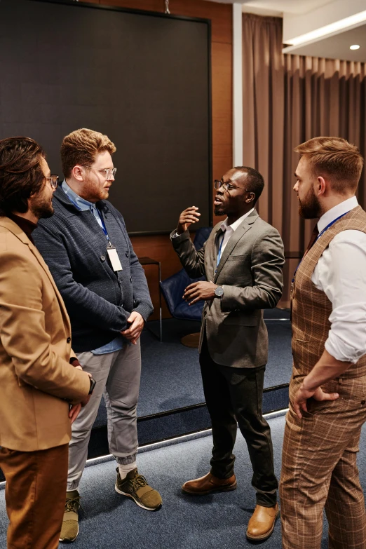 a group of business men standing around each other