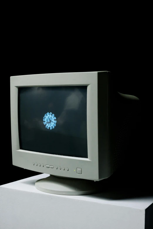 a grey computer monitor with its top open and light coming through