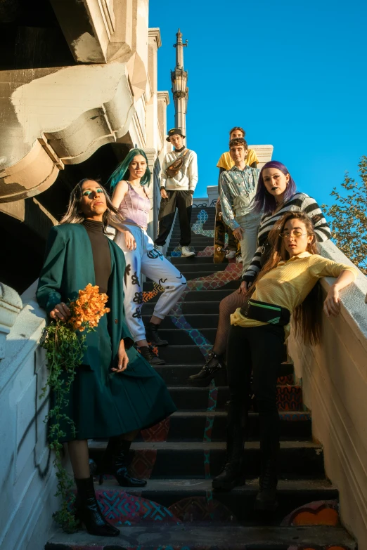 a group of people sitting down some stairs