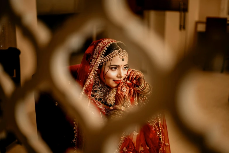 a woman dressed in red is looking through a hole