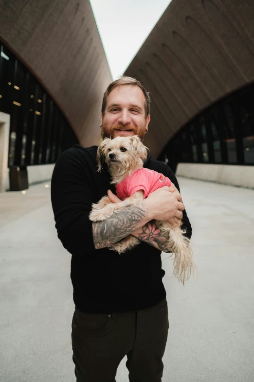 a man holding a dog in his hands