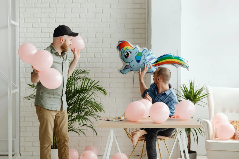 a man is handing a stuffed toy pony to a woman who holds up balloons