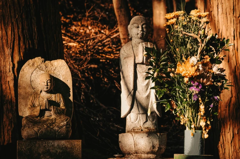 there is a statue next to some vases on a table