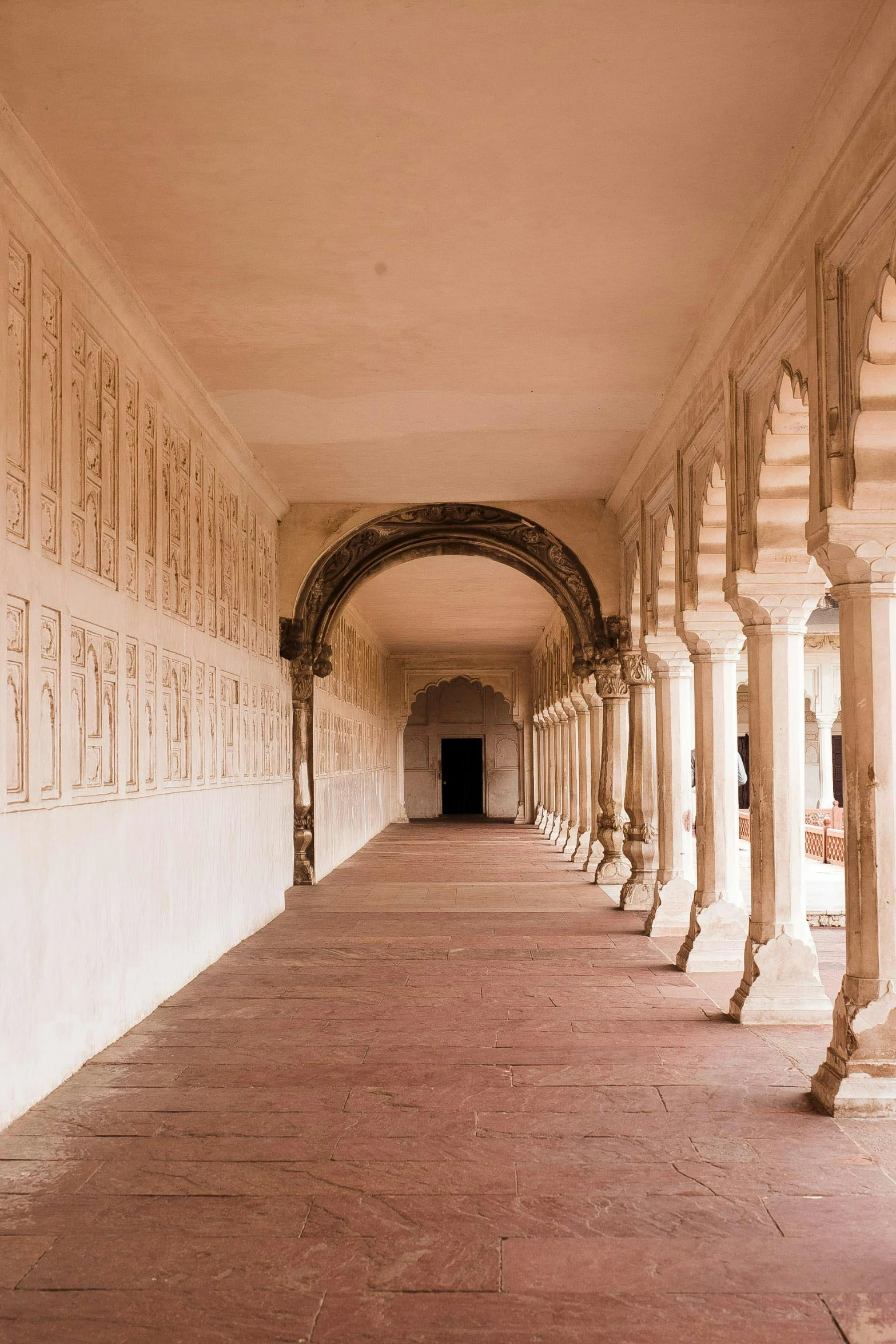 a long, white building with some ornate columns and arches