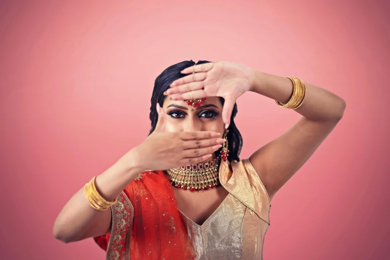 indian woman covering her eyes with her hands