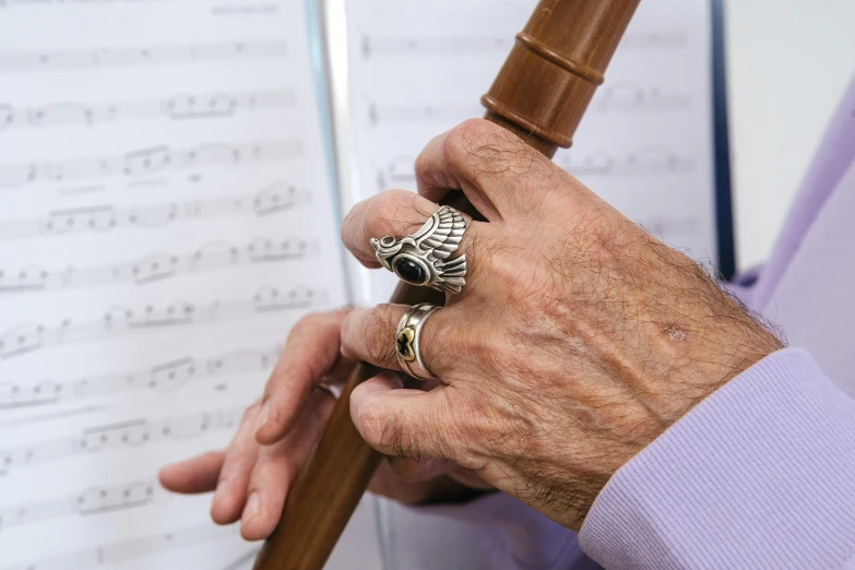 man with a wooden hammer and a ring on his fingers