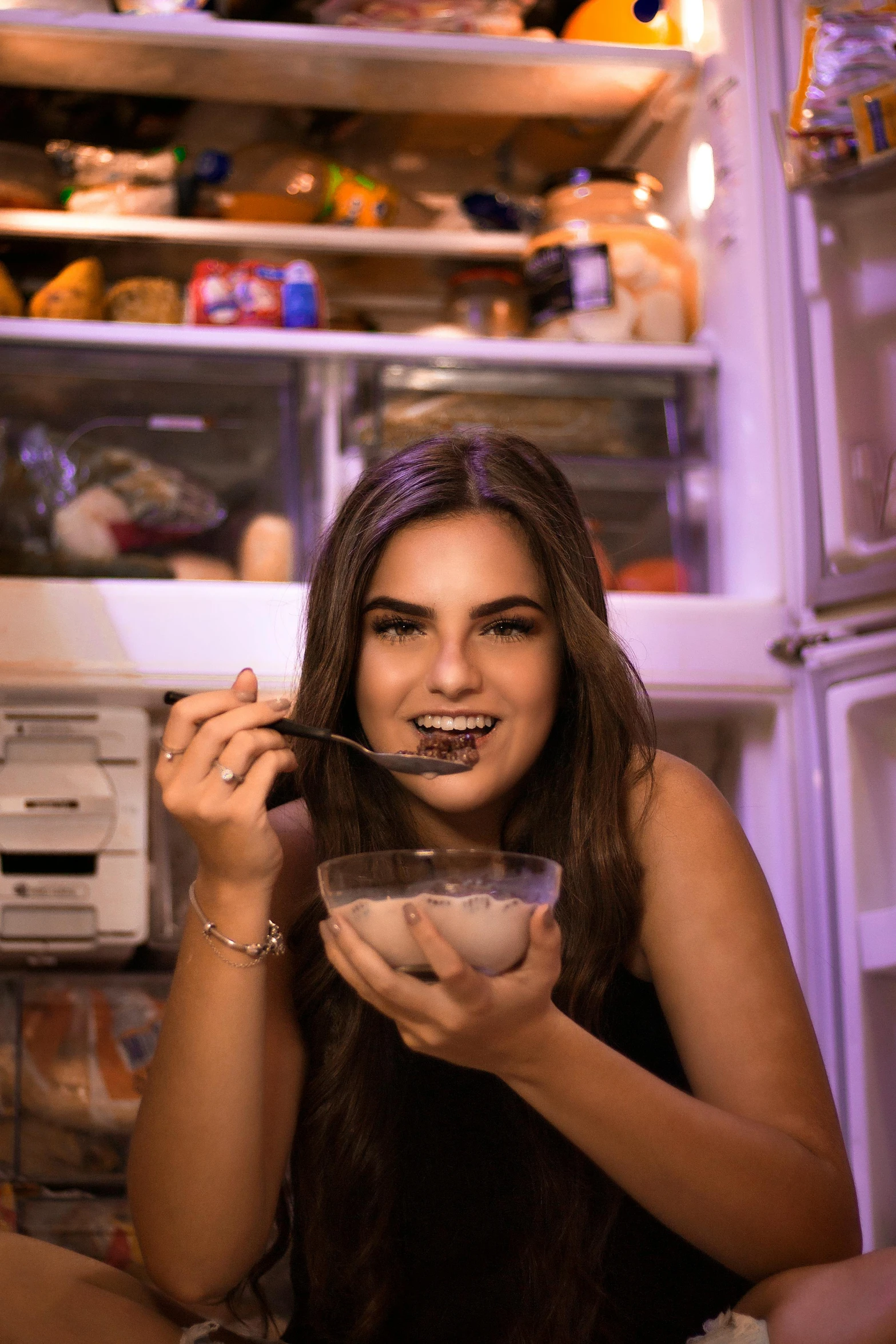 a young woman eating cereal from a bowl