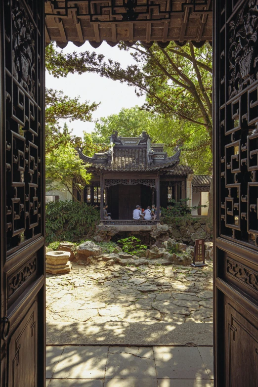 a wooden gate leads to an outside living area