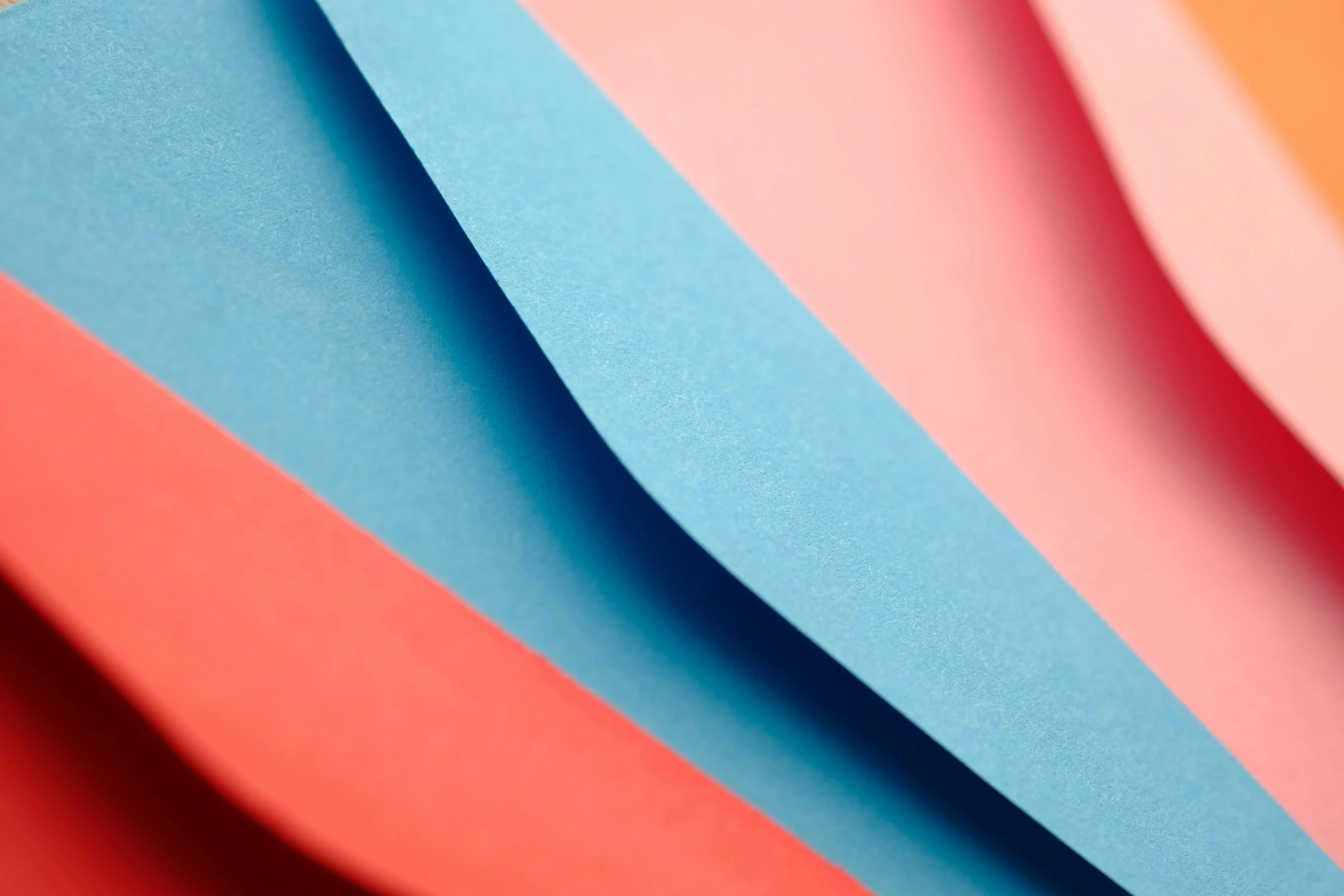 many different colored pieces of paper are stacked in formation