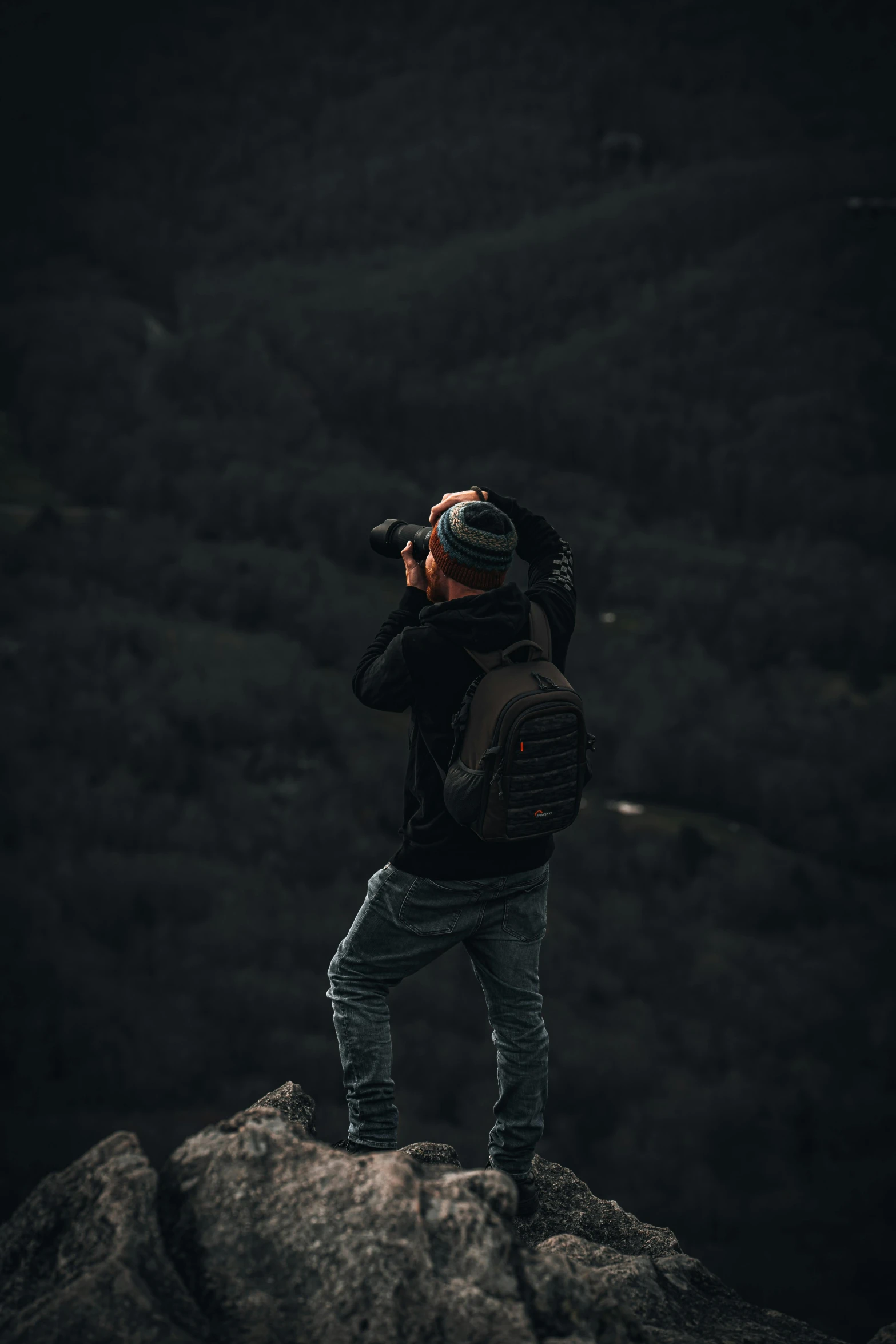 a person with a camera looking through binoculars