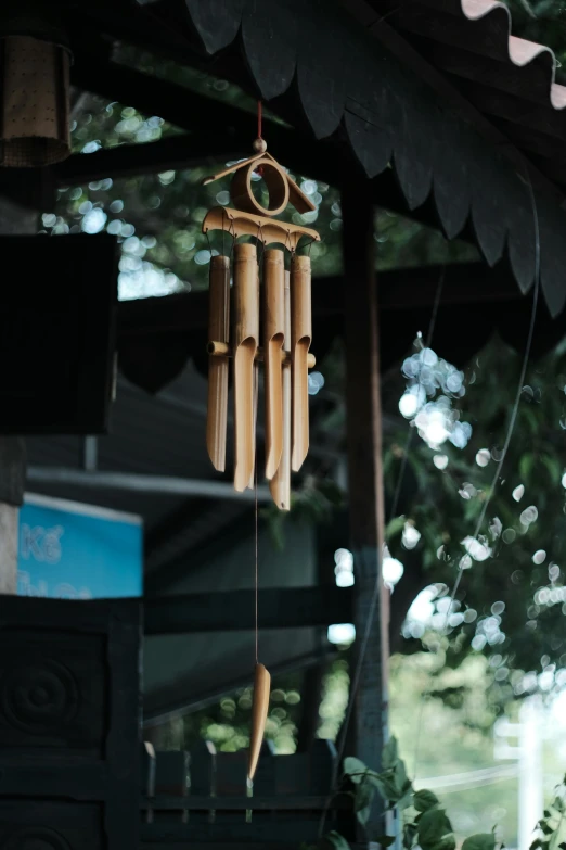 a wooden wind chime hanging from a string