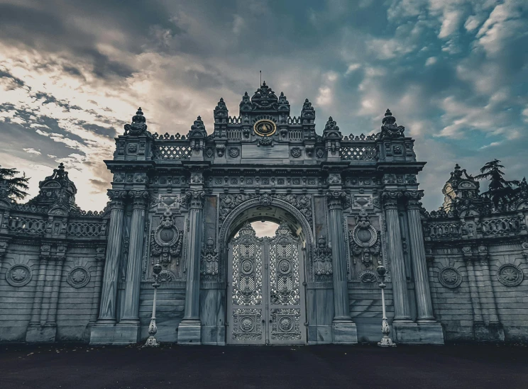 an ancient gate is surrounded by pillars and an elaborate doorway