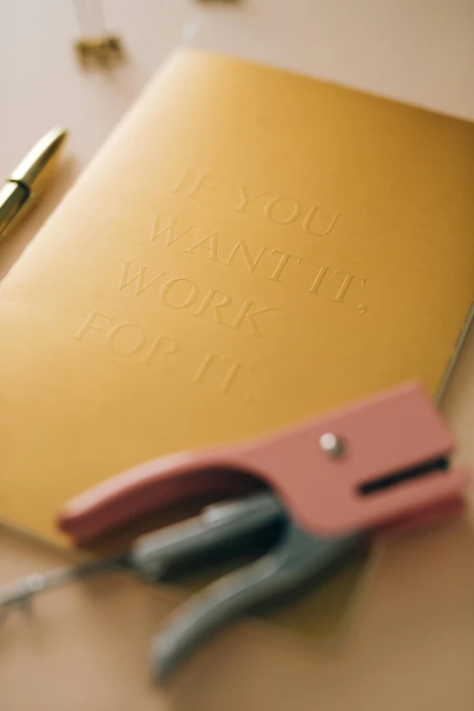 a book is sitting next to a ballpoint pen and calculator