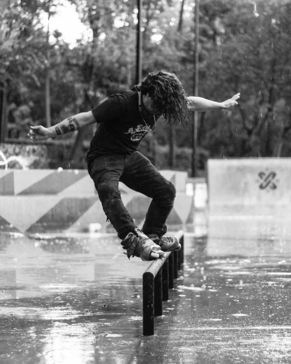 a young man riding a skateboard on top of a wooden beam