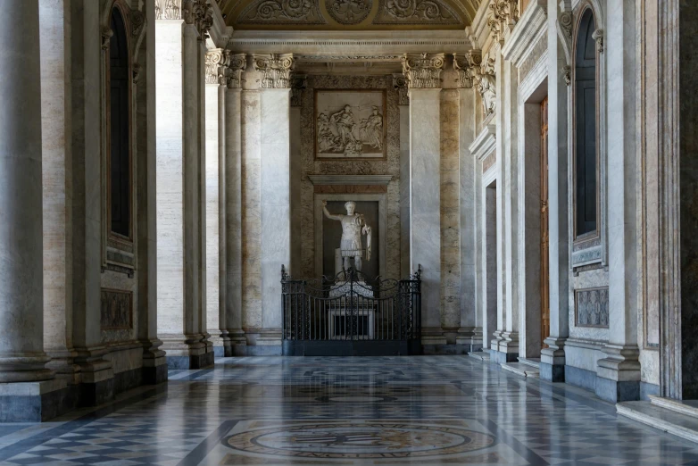 an ornate hallway with columns and statues