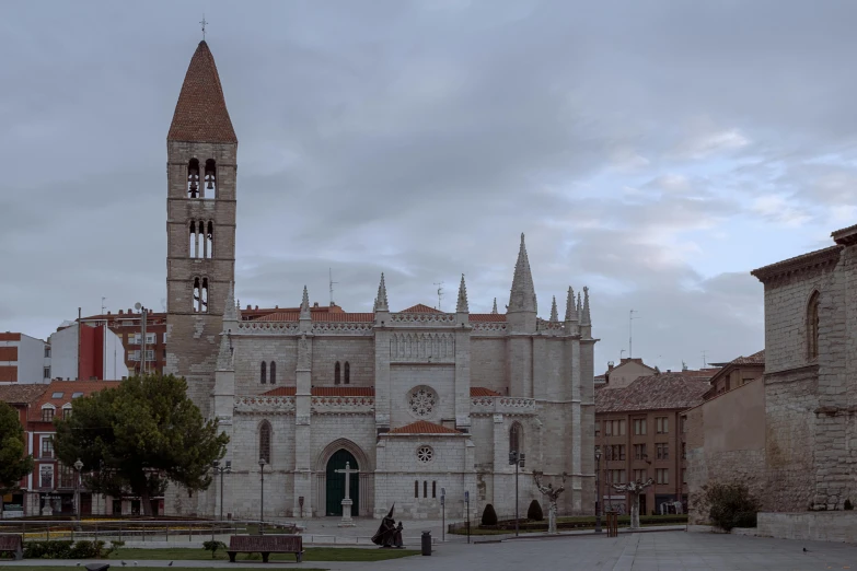 a tall tower with clocks next to a large building