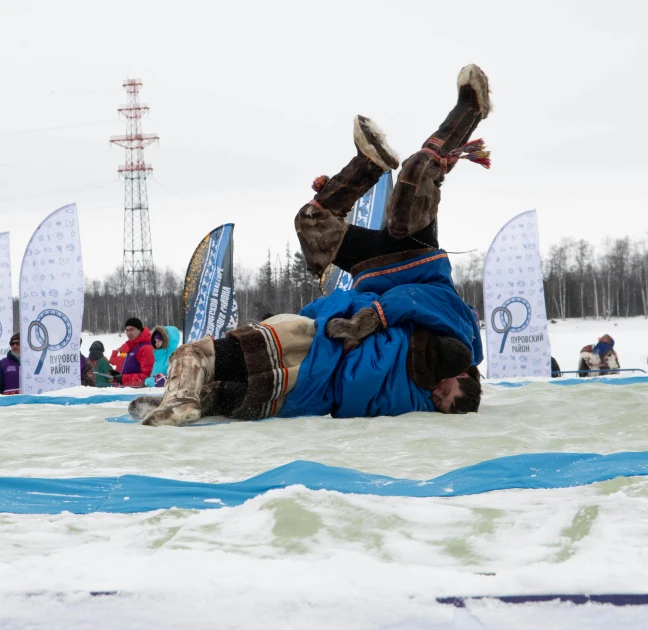 man falls down in water as part of competition